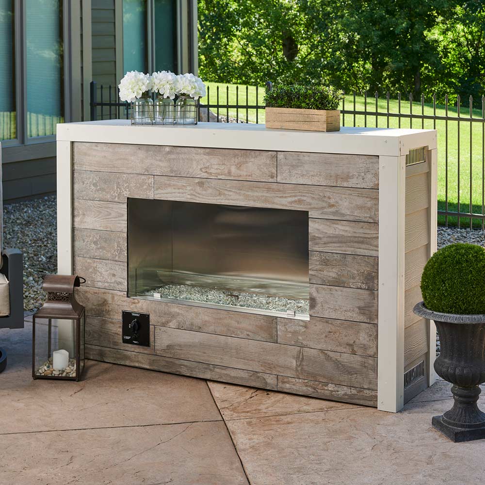 Outdoor linear fireplace insert with glass front and unlit burner tray