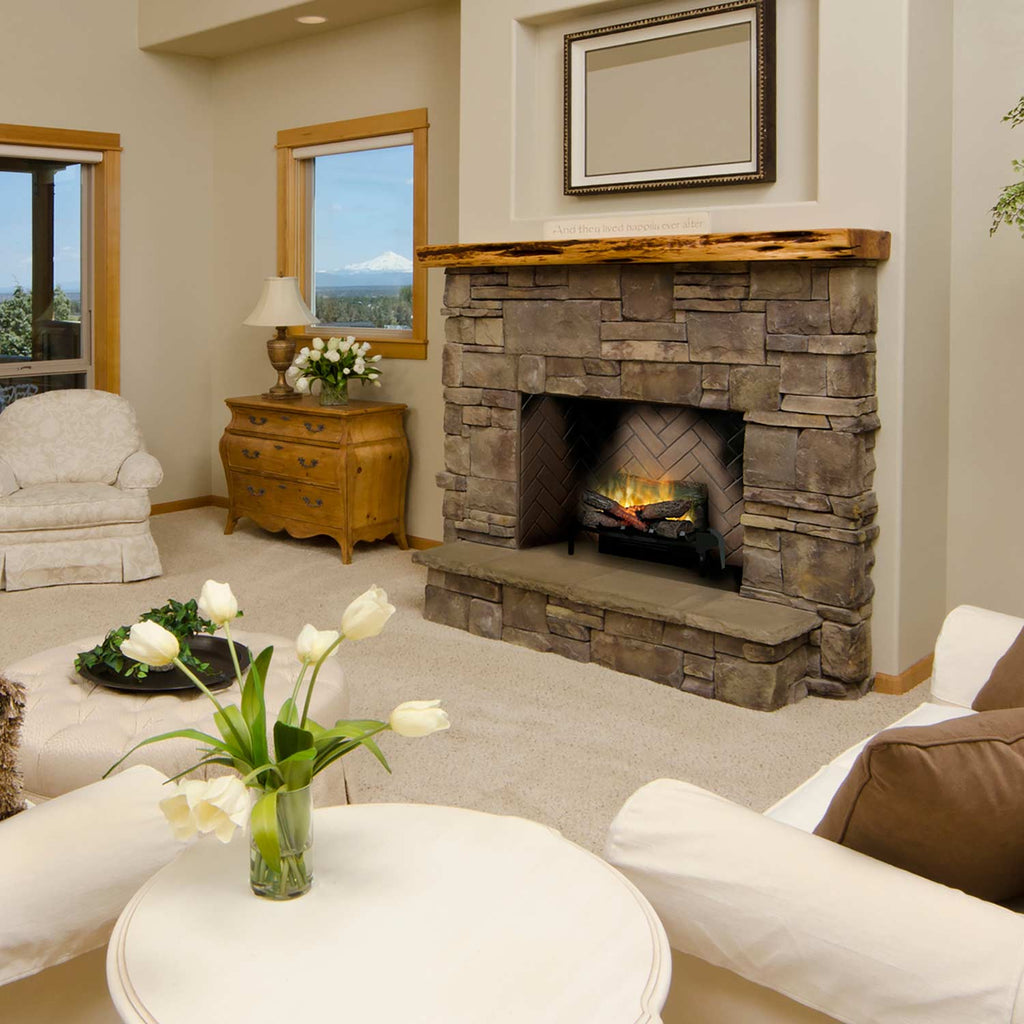 Plug-in electric log set in stone fireplace with faux logs and yellow flame glow
