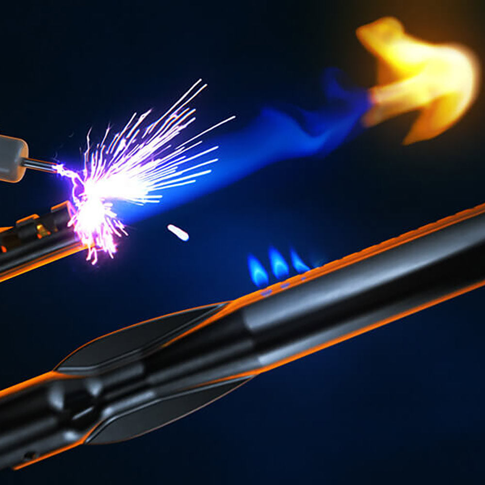 Gas grill burner igniting with visible spark and flame on grates
