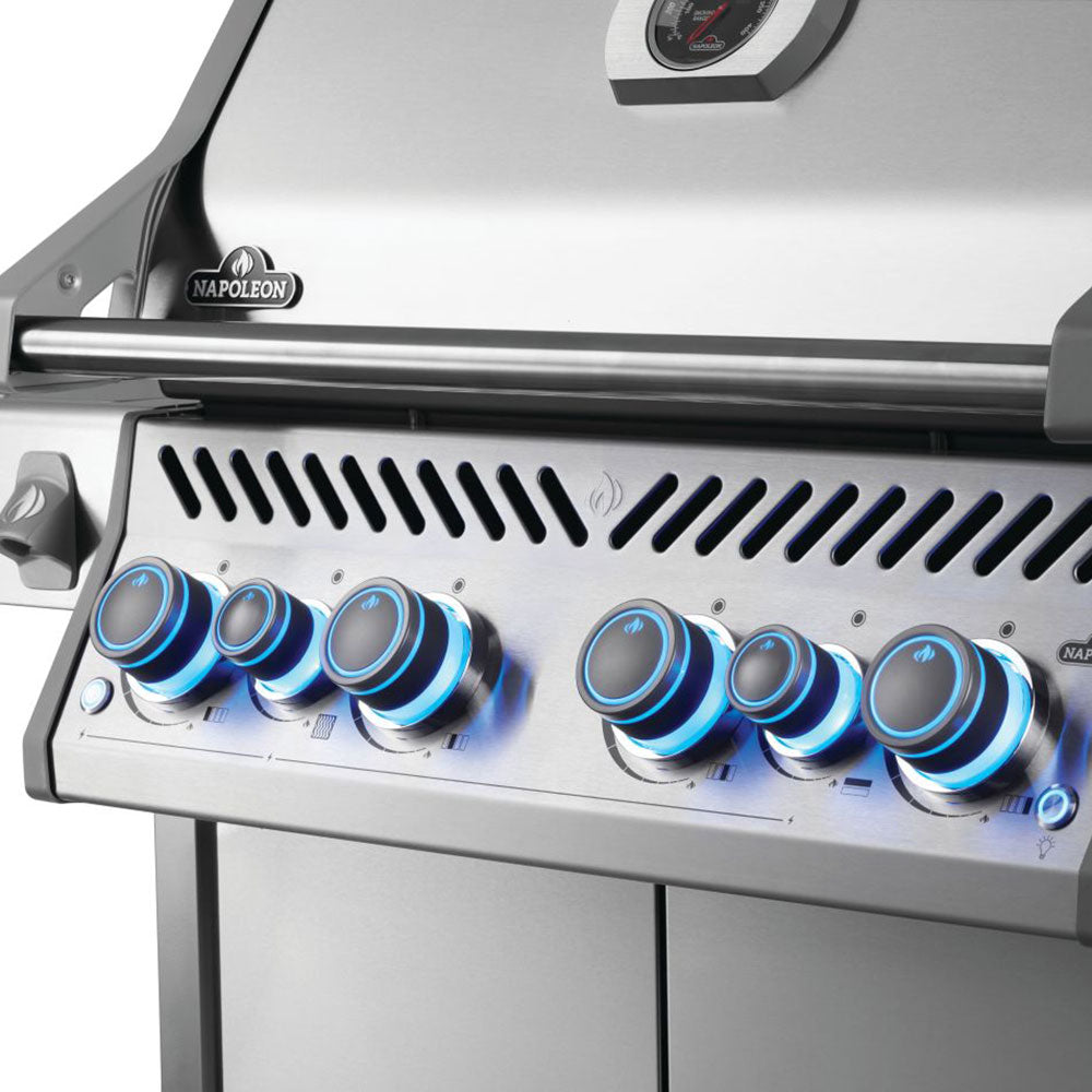 Gas grill control panel with blue knobs and vented burner strip