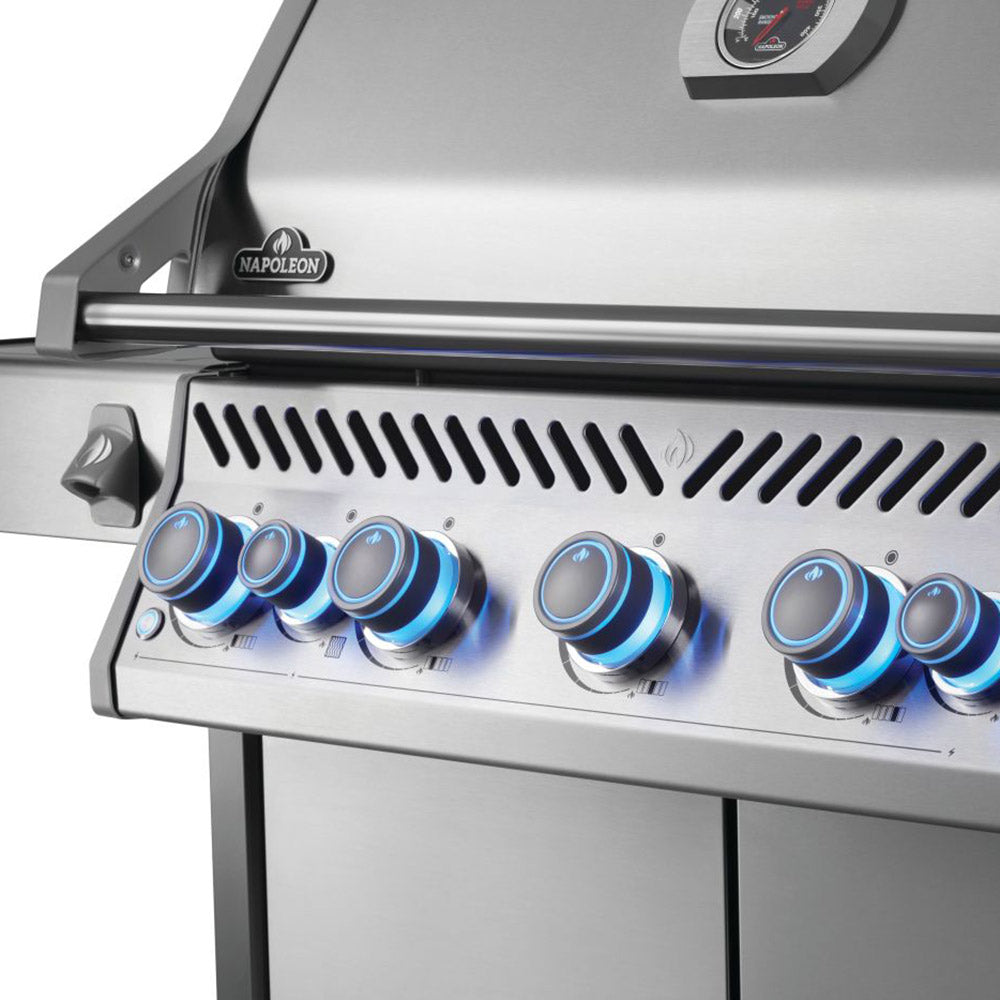 Stainless steel grill control panel with blue-topped gas knobs