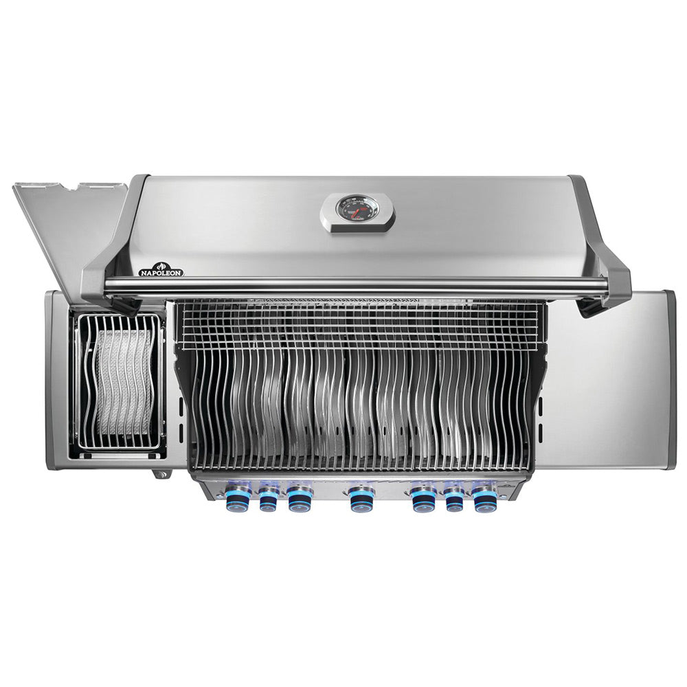 Open gas grill hood showing infrared-style burner grates and blue knobs