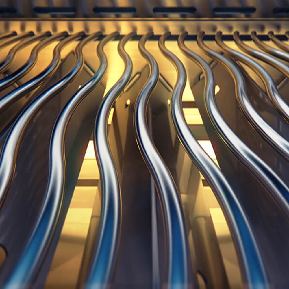 Infrared-style burner tubes inside a stainless steel gas grill