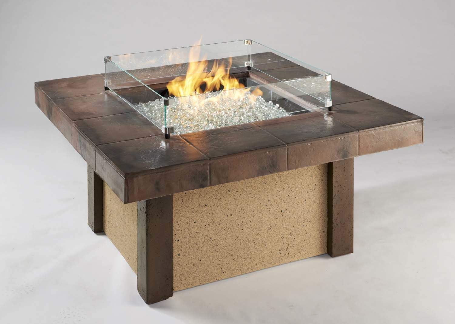 Outdoor square glass wind guard around burning fire on tabletop base