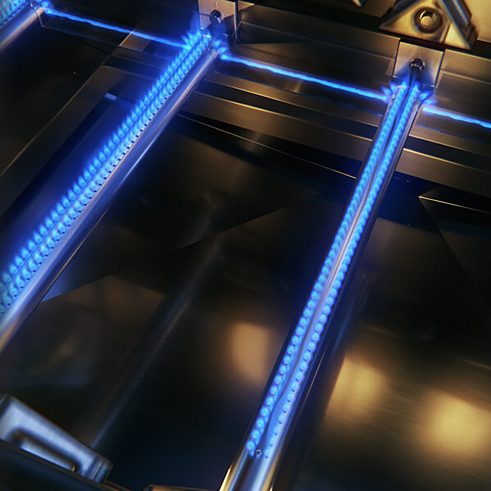 Gas grill burner tubes glowing blue inside the firebox