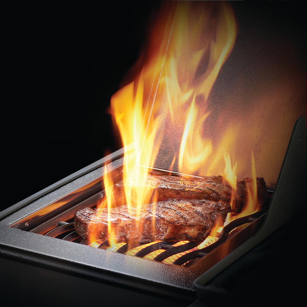 Gas grill with open flame over cooking grates
