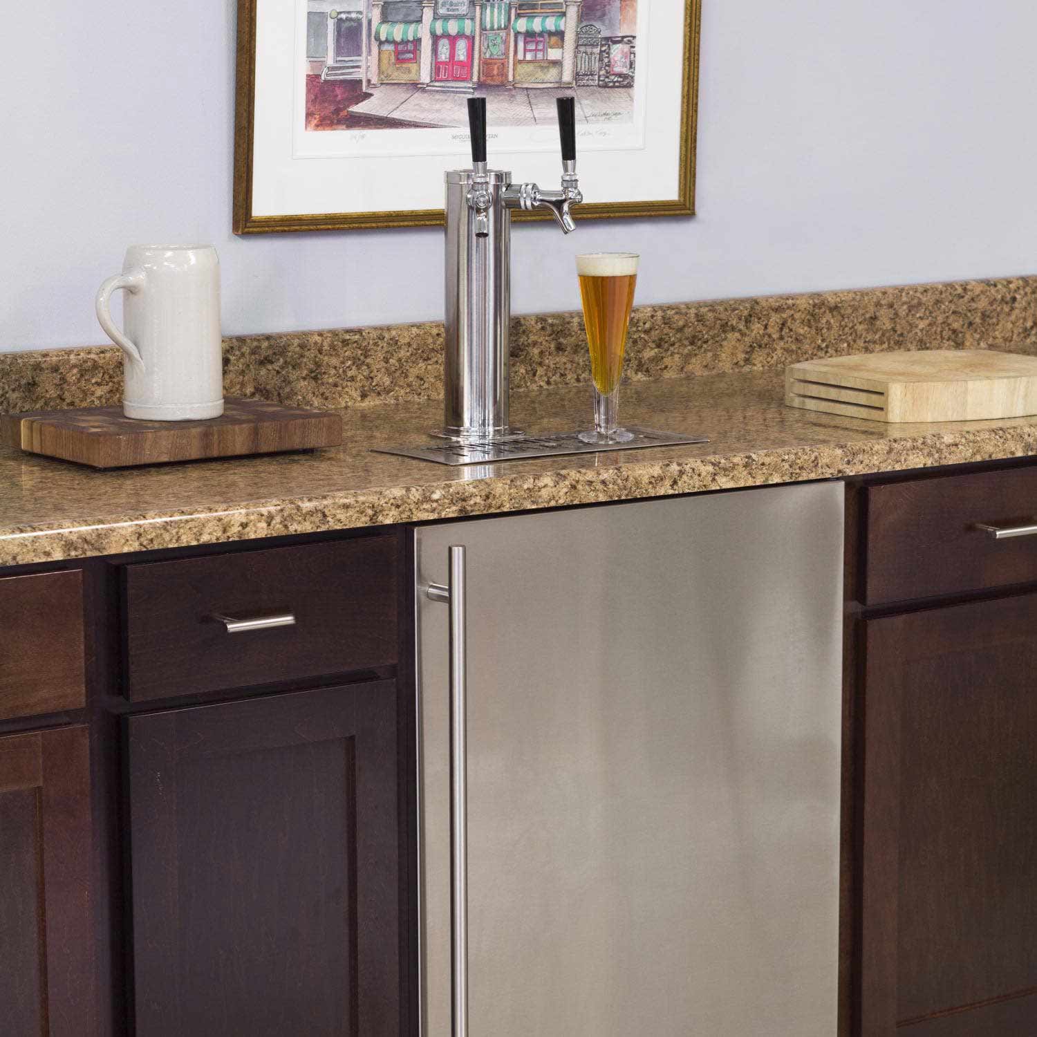 Beer tap with a glass of beer on a kitchen counter