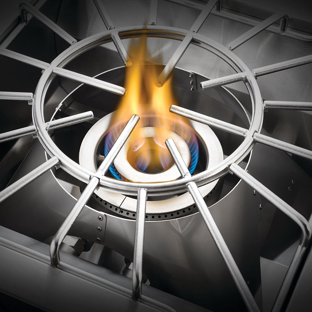 Stainless steel burner grate with crossed supports over lit gas flame