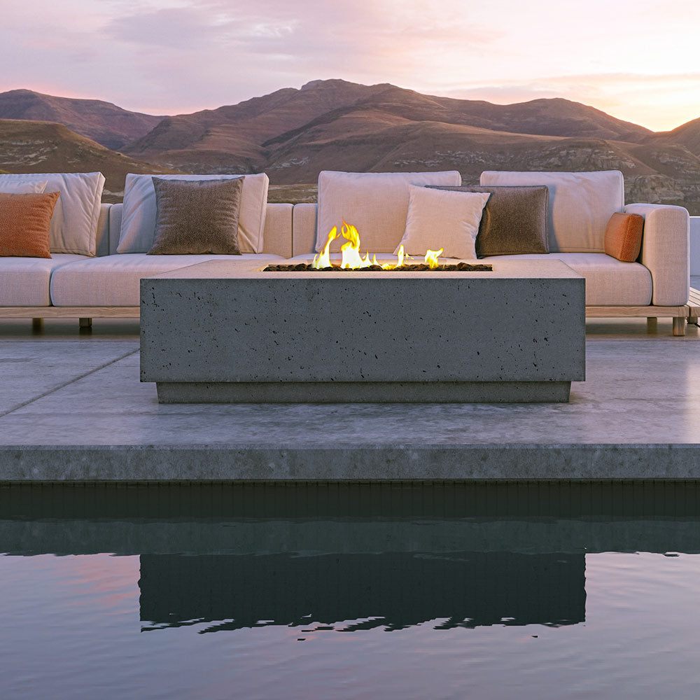 Sanctuary gas fire table with active flames in the center opening, stone base