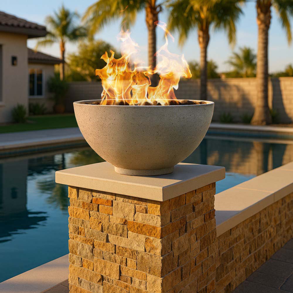Gas fire bowl on stone column, tan finish with flames rising from open basin