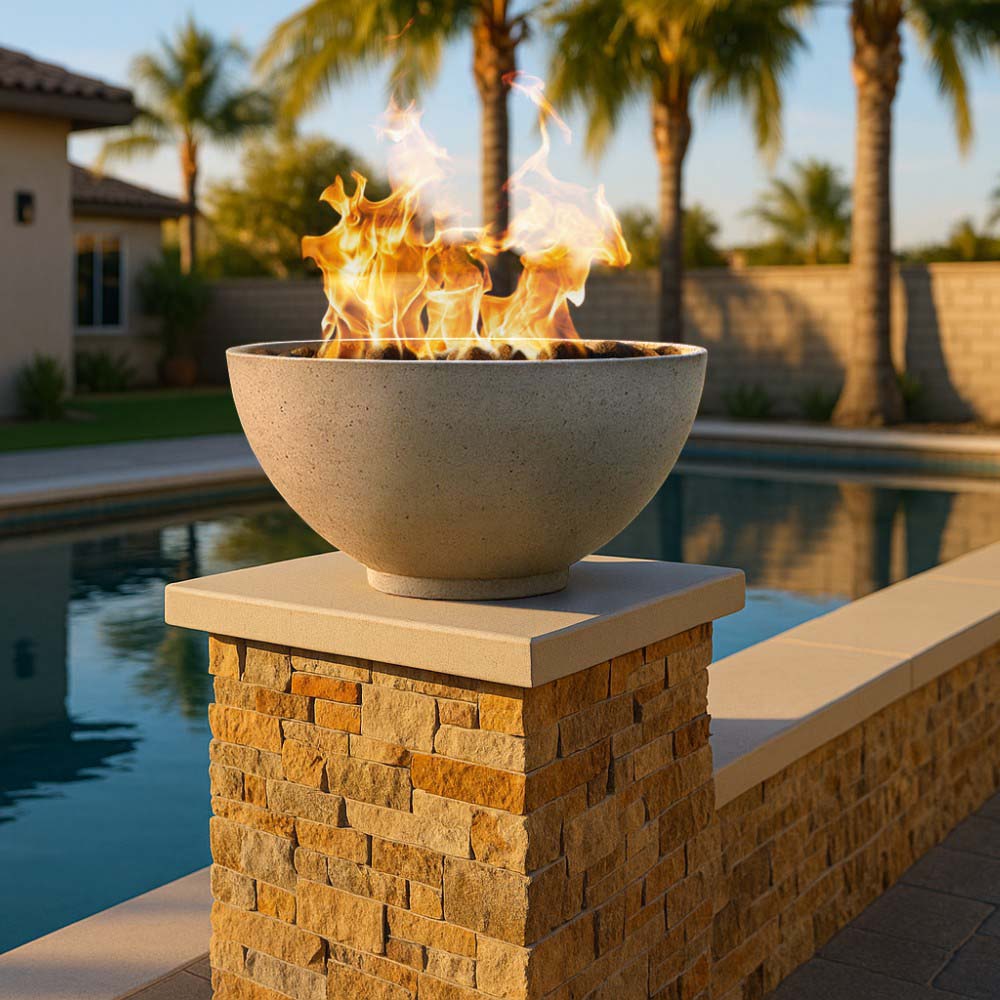 Concrete gas fire bowl with bright flames on stone pedestal