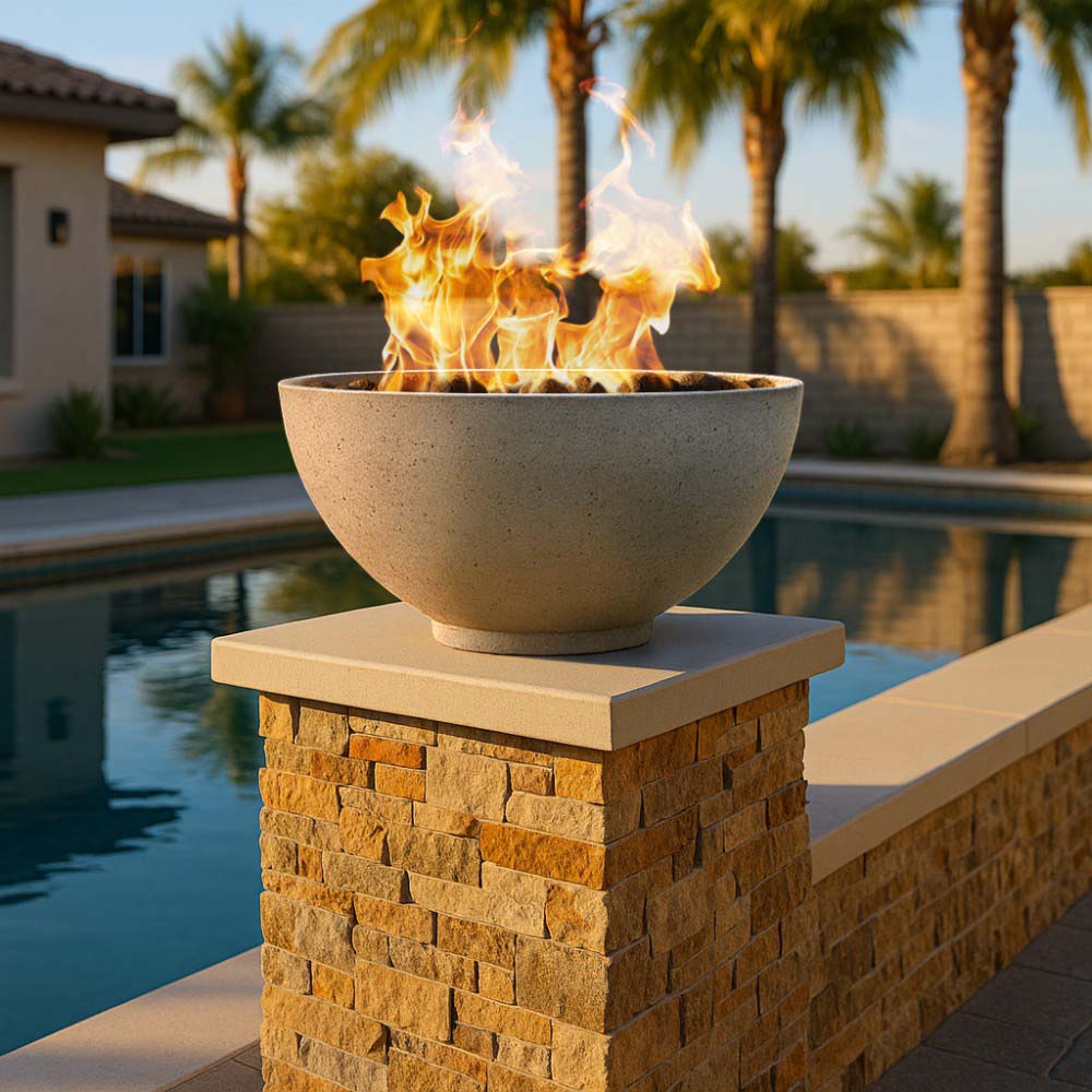 Outdoor gas fire bowl with flames on a square stone pedestal