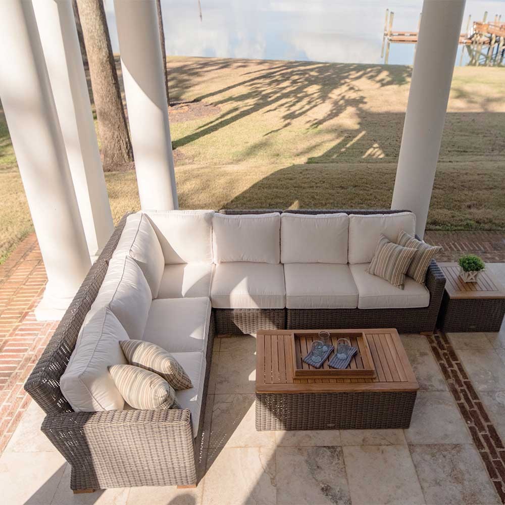 Outdoor corner sectional with right arm facing and light gray seat cushions