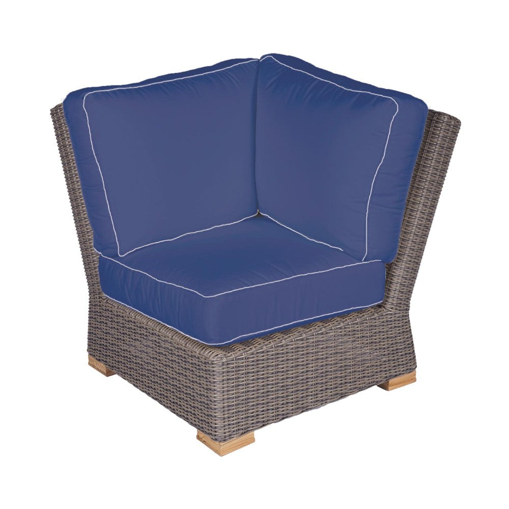 Outdoor corner chair with blue cushion and dark wicker frame