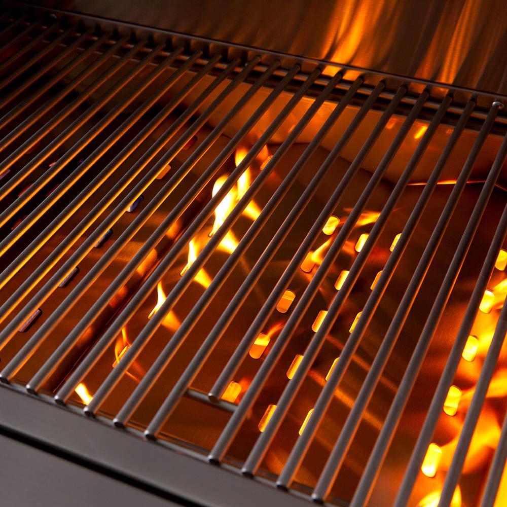 Gas grill burners glowing orange with visible flames under the grates