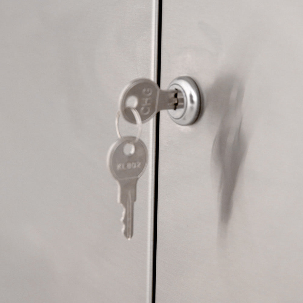 Gas grill cabinet door lock with keys hanging on the handle