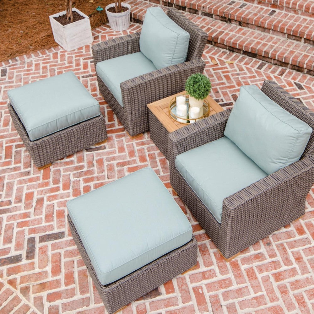 Woven wicker ottoman with light teal upholstered cushion