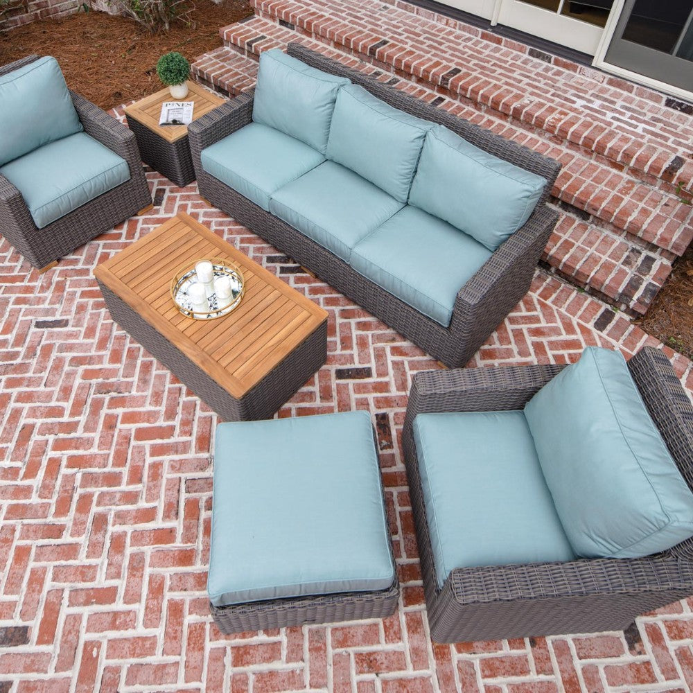 Outdoor sofa with dark wicker frame and aqua blue seat and back cushions