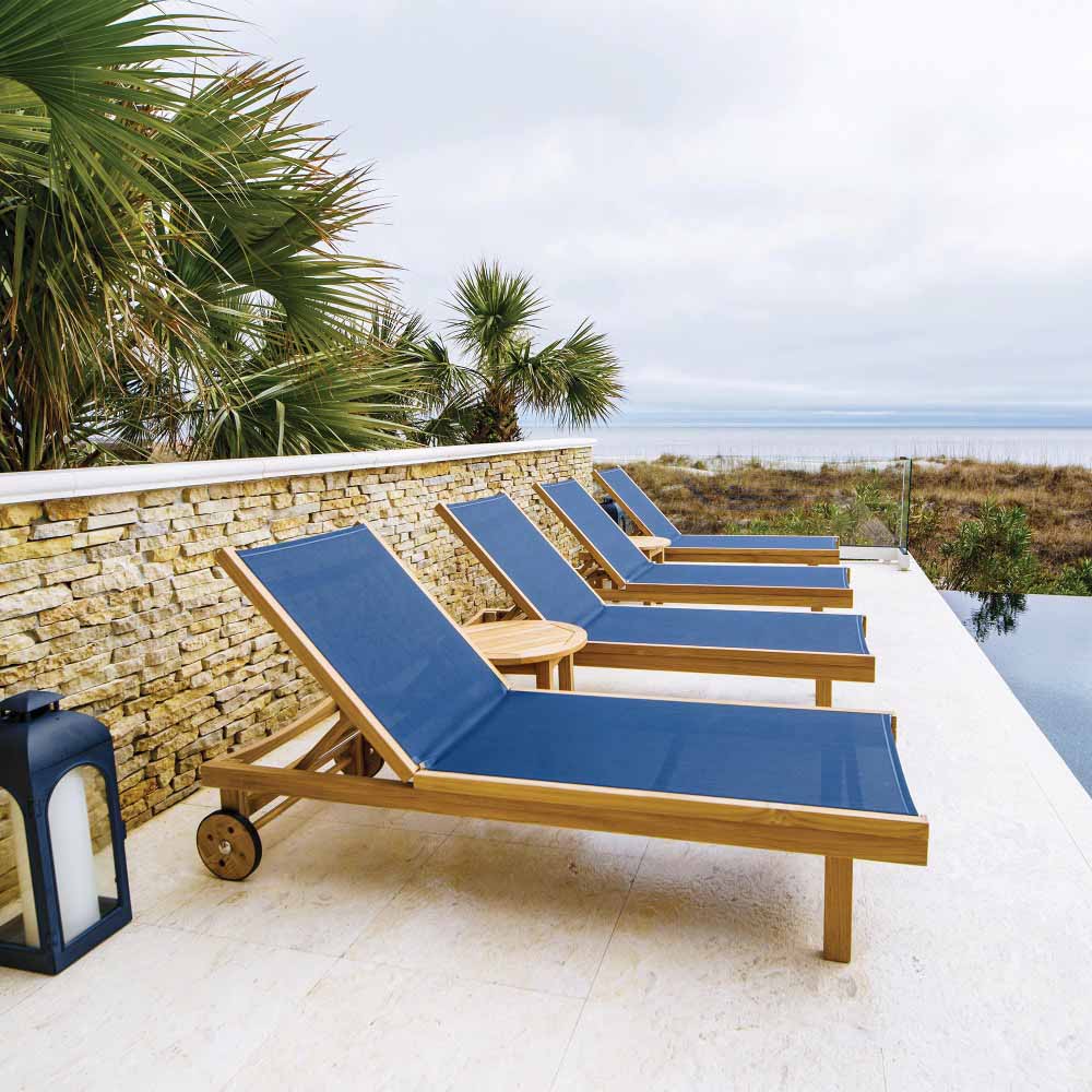 Teak chaise lounge chair with blue sling seat and adjustable back, rolling casters
