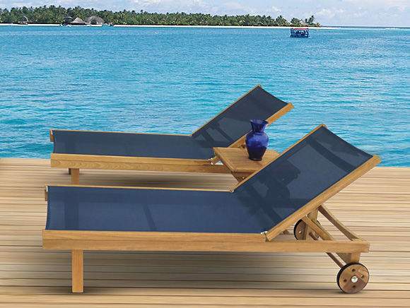 Teak sling lounge chair with dark navy sling, wooden frame, and caster wheels
