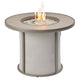 Round light gray gas fire table with mesh sides and flames burning in center