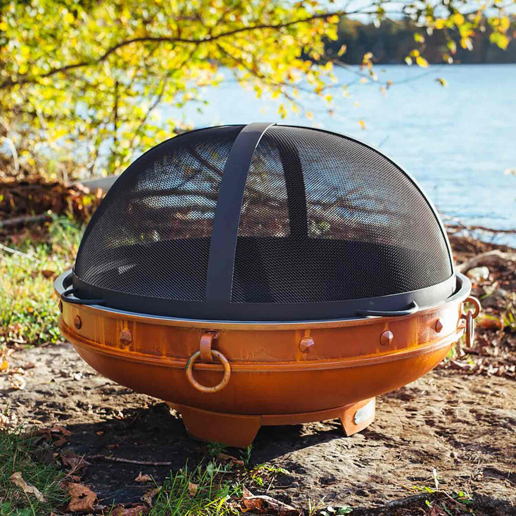Fire pit spark guard, black mesh dome with orange metal base and round hinged rim
