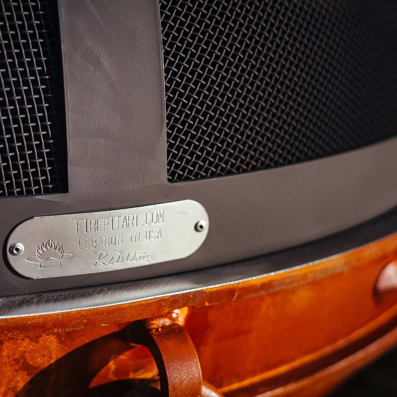 Fire pit spark guard nameplate on gray frame with black diamond mesh side