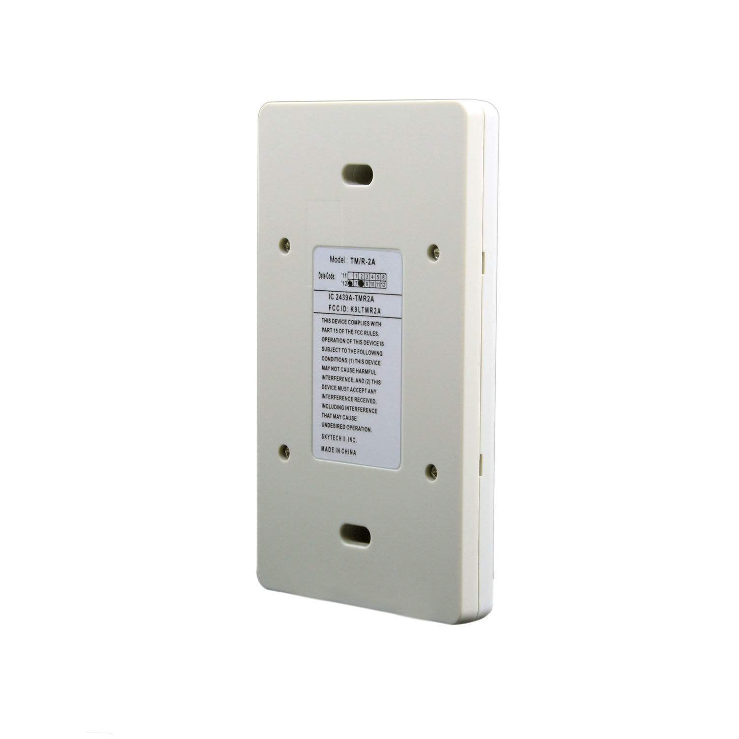 Transmitter remote back panel in light gray with screws and specifications label