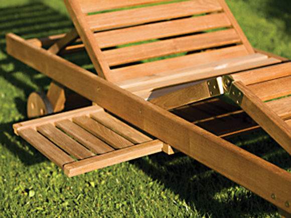 Teak sun lounger close-up with slatted frame and wheel-mounted base