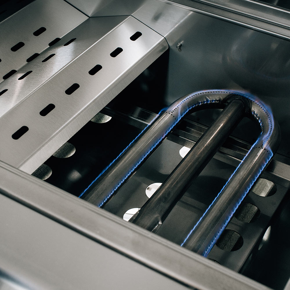 Gas grill burners glowing under cooking grates, with blue flame tones