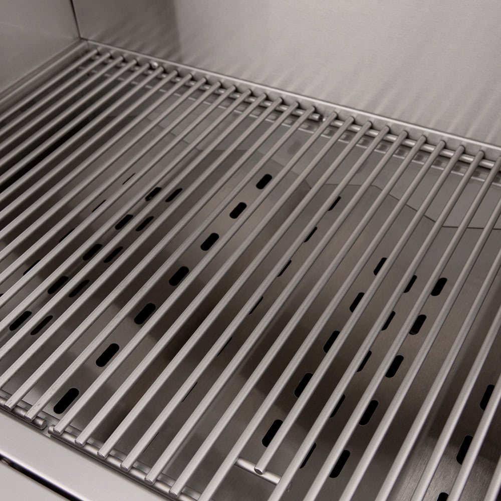 Stainless grill grates with slotted burner heat deflector bars inside a gas grill
