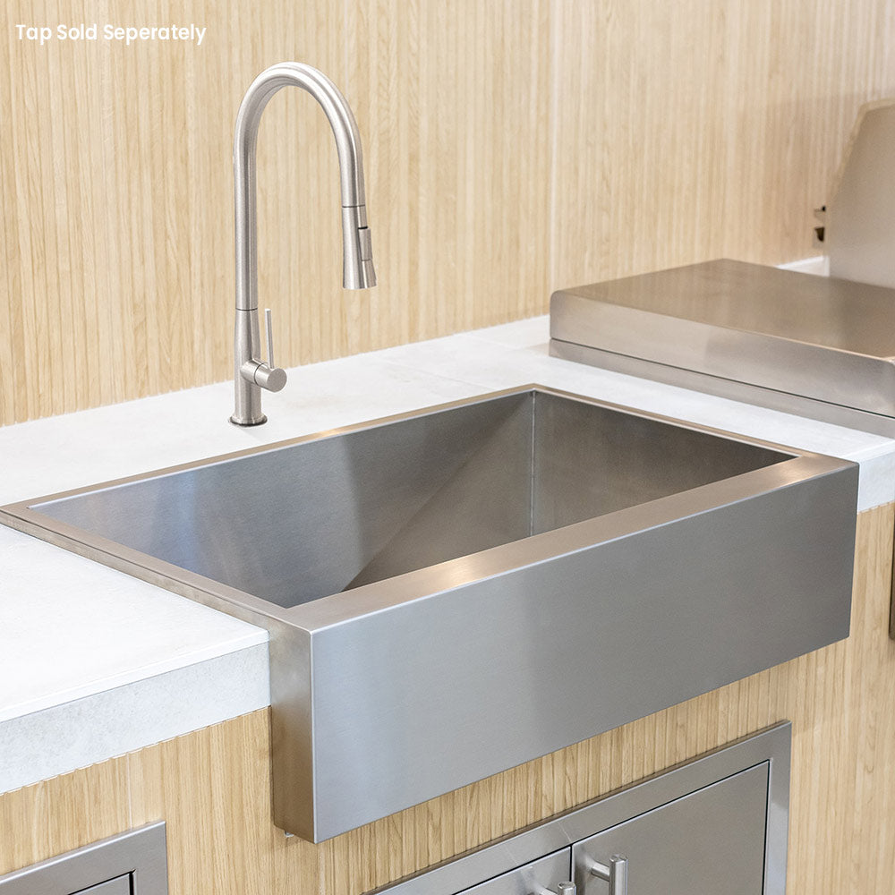 Stainless steel farmhouse sink with high-arc faucet and flat apron front