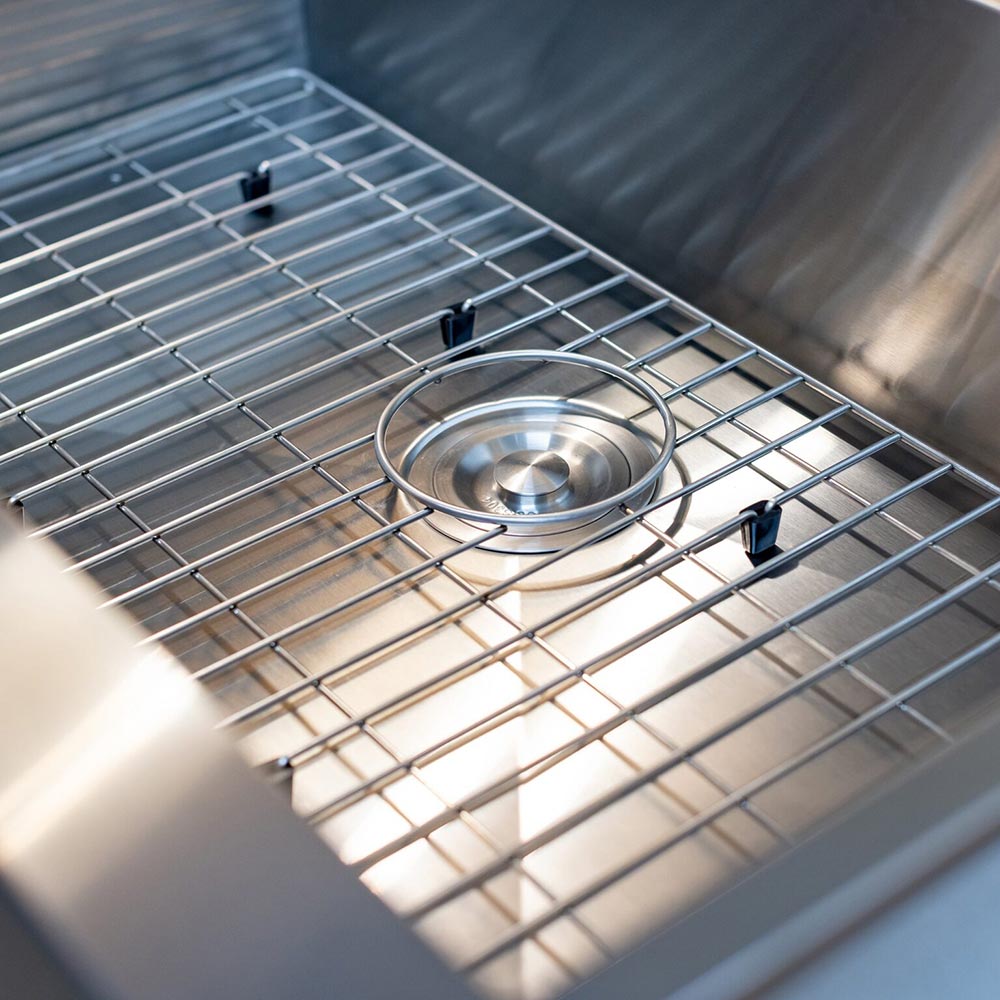 Stainless steel sink basin with wire dish rack and round drain strainer