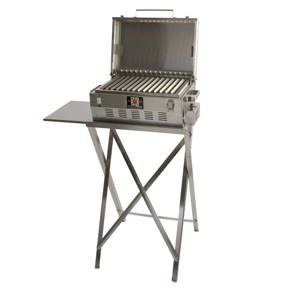 Stainless steel portable infrared grill on folding stand, lid open with ribbed cooking grate