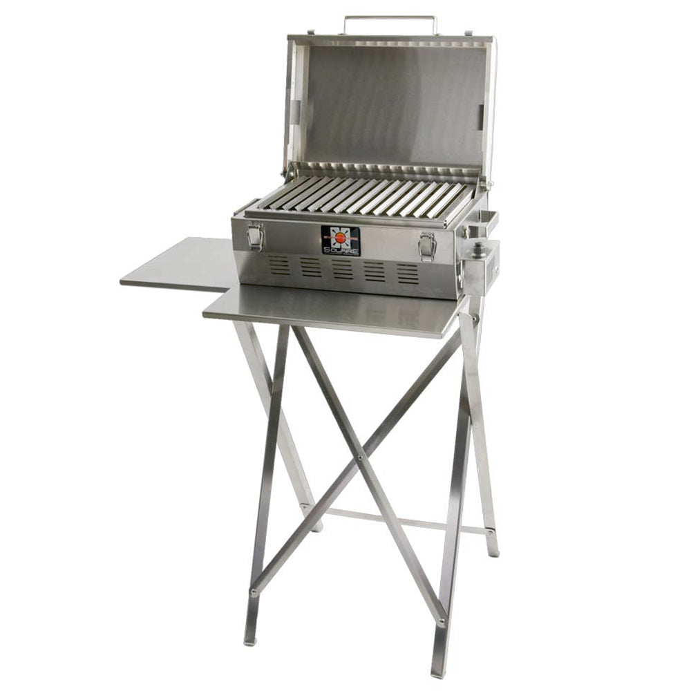 Stainless steel portable infrared grill on folding stand, lid open over ribbed grate