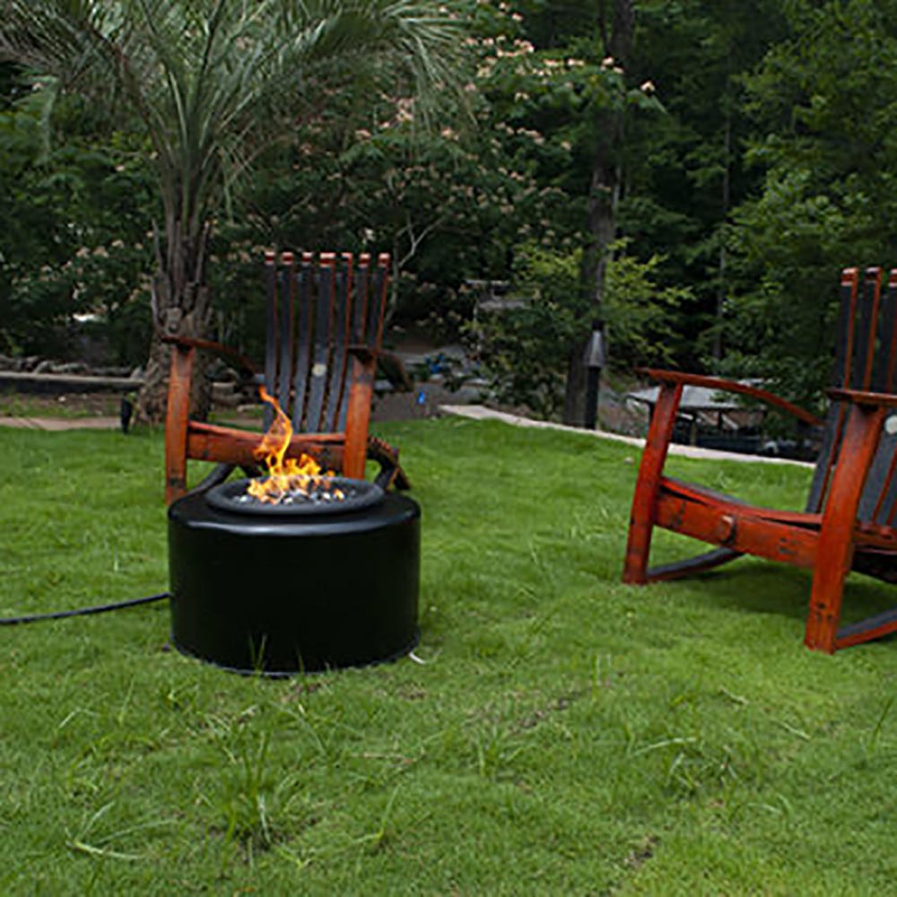 Outdoor round fire pit with visible flames, dark black unit