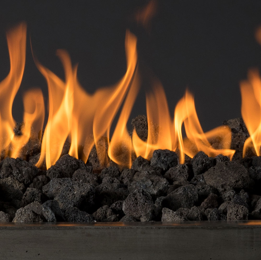 Lava rock fuel bed with black stones and open flames