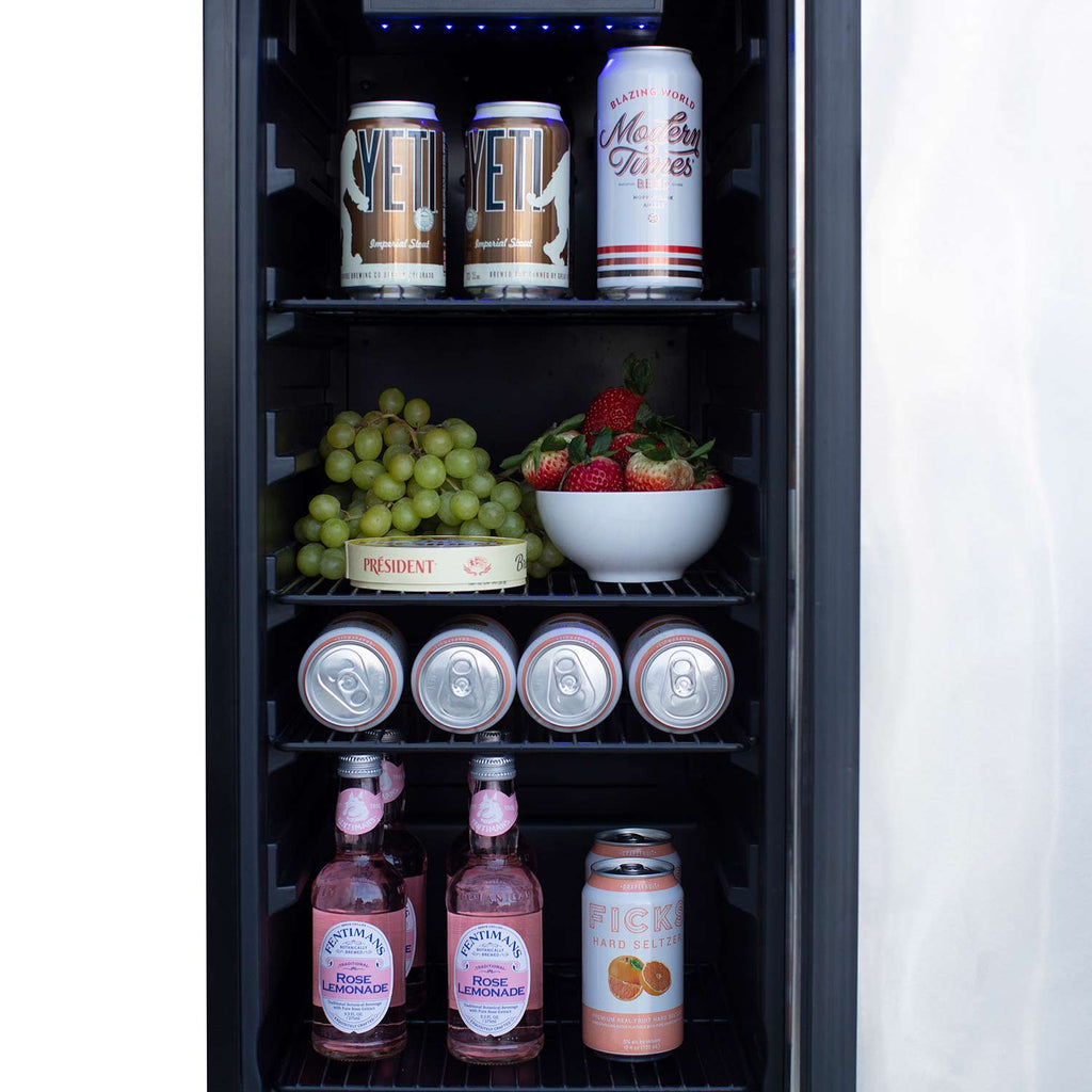 Refrigerator interior with blue lighting, cans, bottles, and produce on shelves