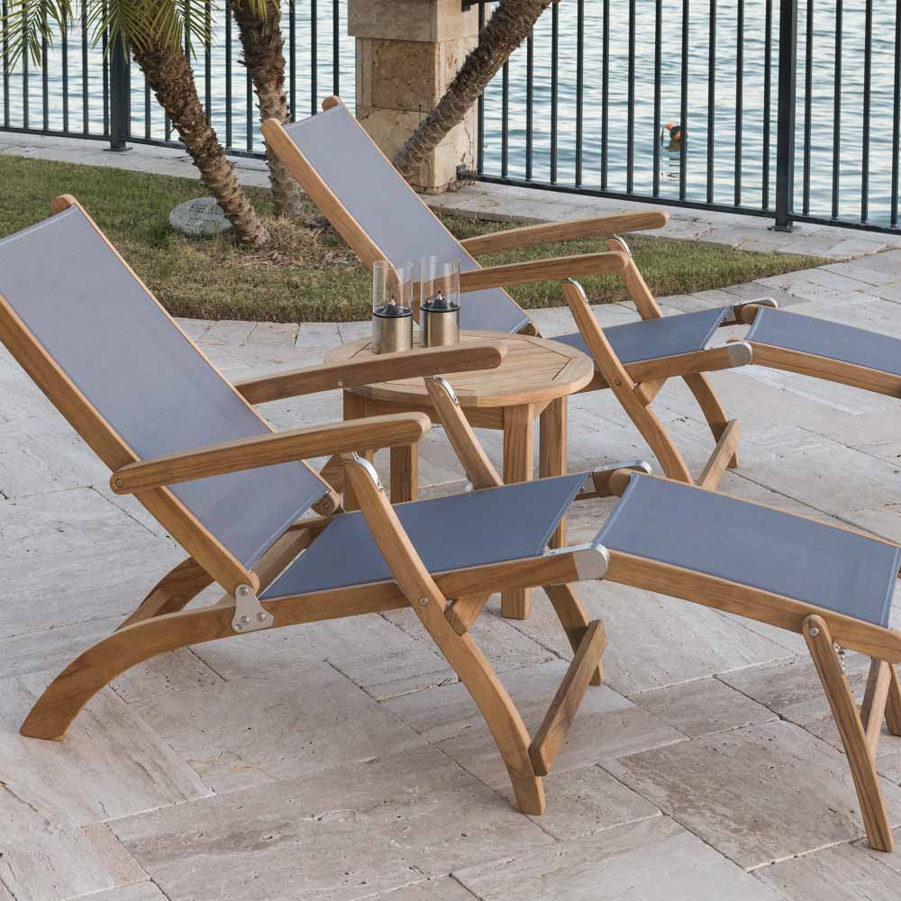 Teak sling steamer lounge chairs with gray fabric seats and adjustable backrests