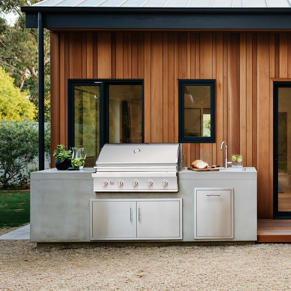 Built-in stainless gas grill unit with control panel and side cabinet doors