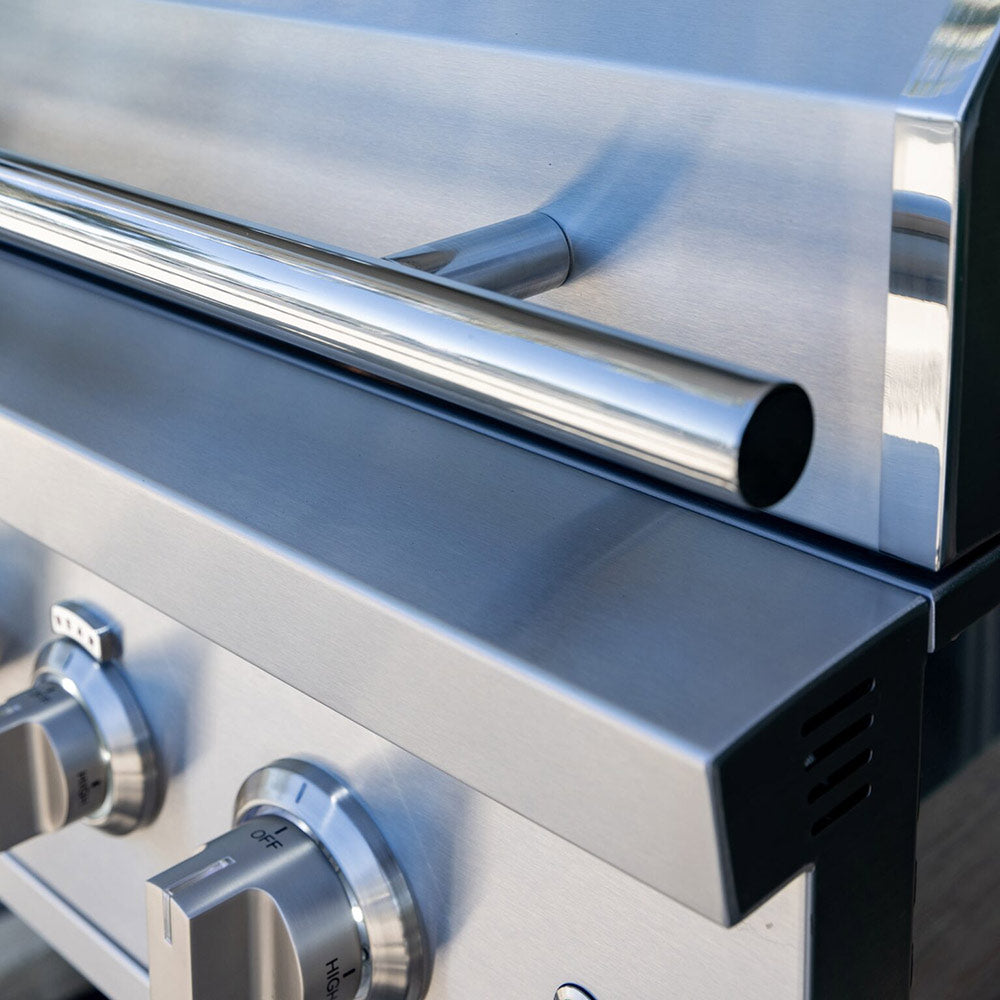 Stainless gas grill side shelf area with control knob and vented panel