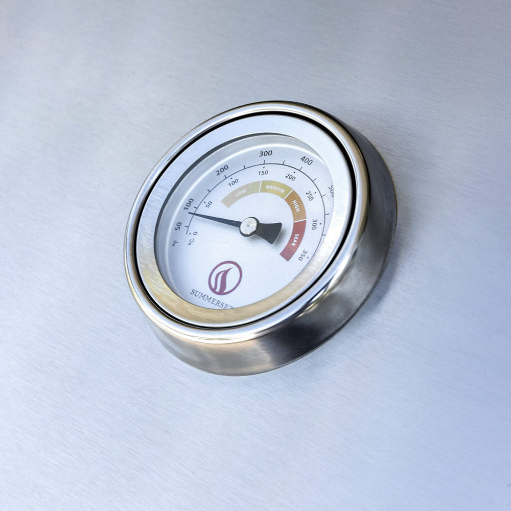 Stainless temperature gauge on the gas grill lid with heat range markings