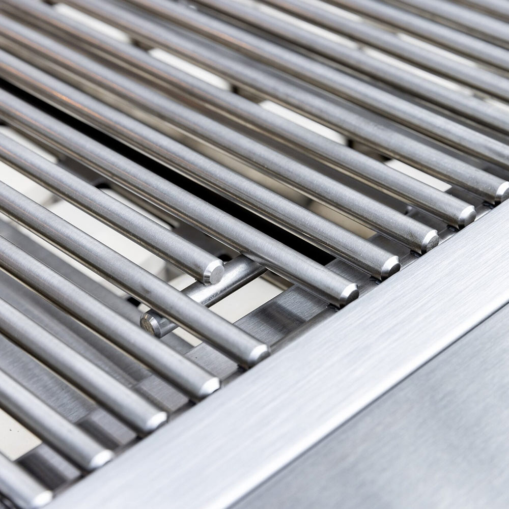 Stainless grill burner tube array beneath cooking grates