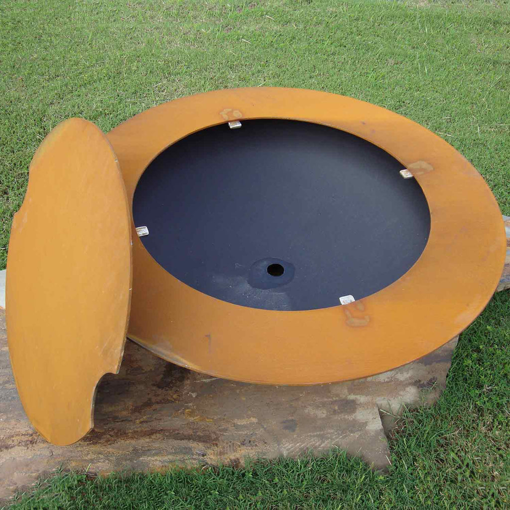 Round gas fire pit with hinged lid open, black burner interior and tan outer body