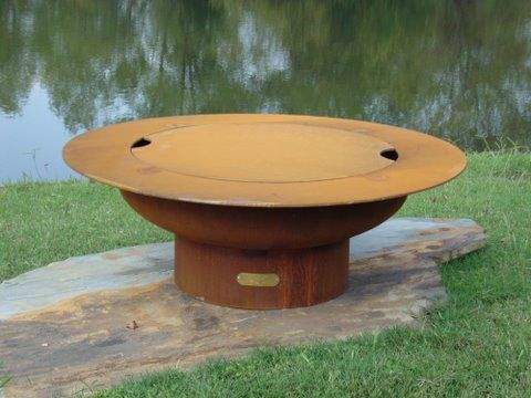 Wood fire pit with flat lid and circular burner opening, rust orange finish
