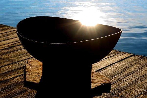 Black wood fire pit bowl with burning fire and wide rim