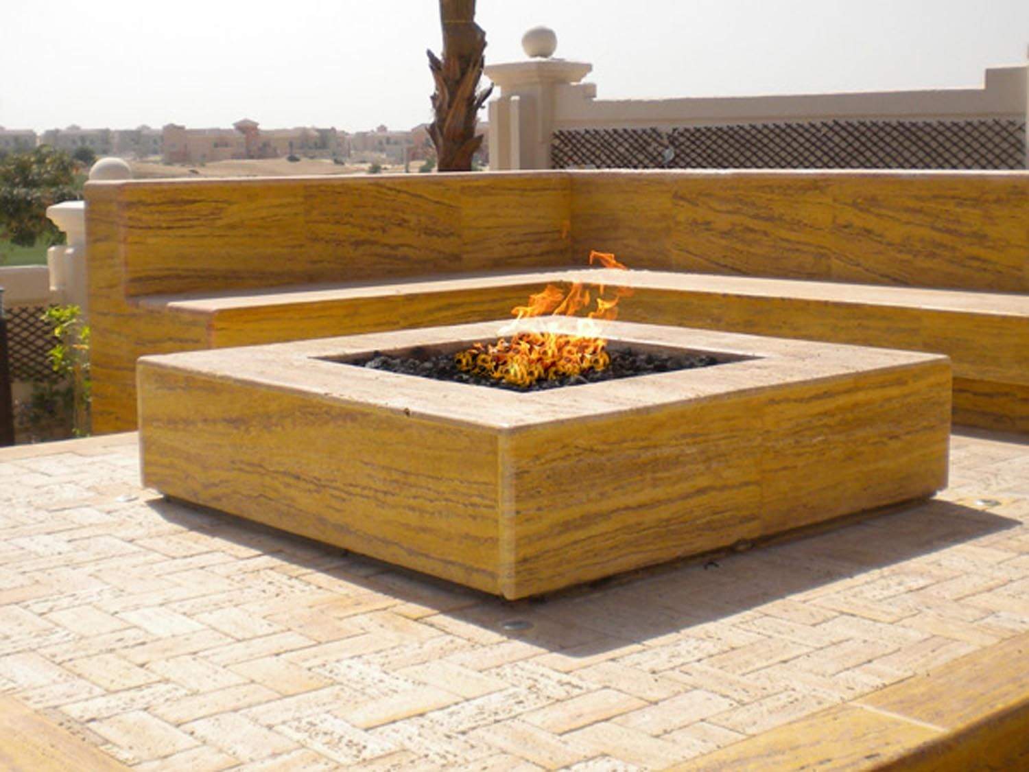 Square gas fire pit burner unit in a wooden enclosure, with visible open fire tray