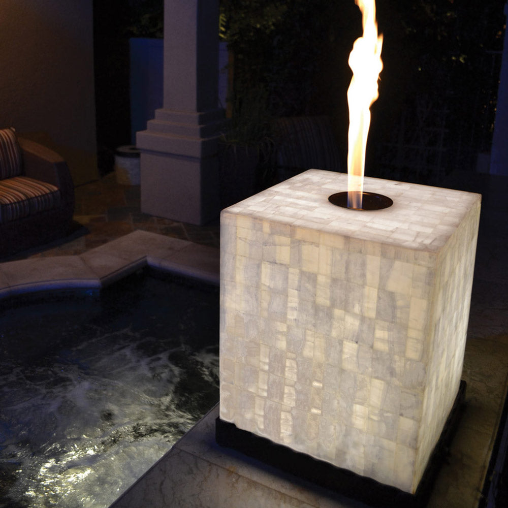 Square white quartz stone floor candelere with lit flame and round top burner