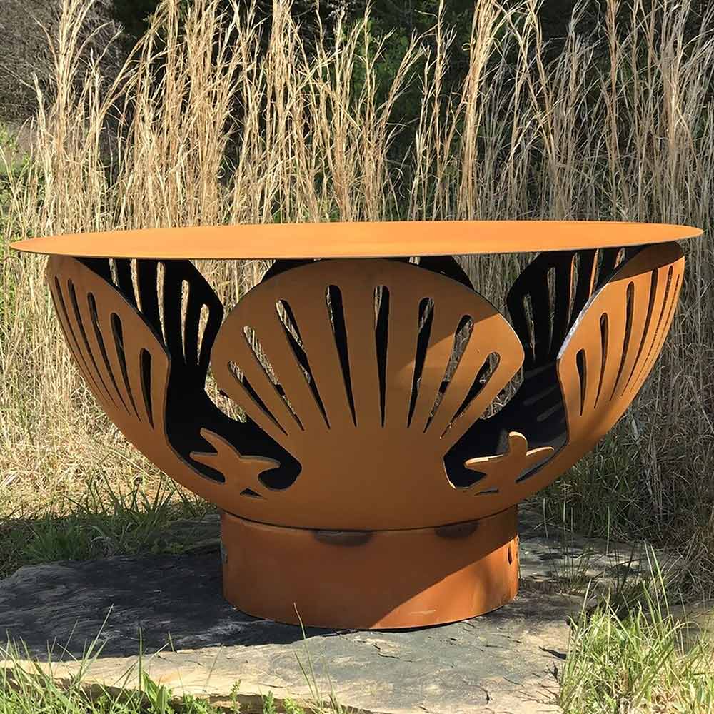 Orange metal fire pit with cutout flame pattern round tabletop