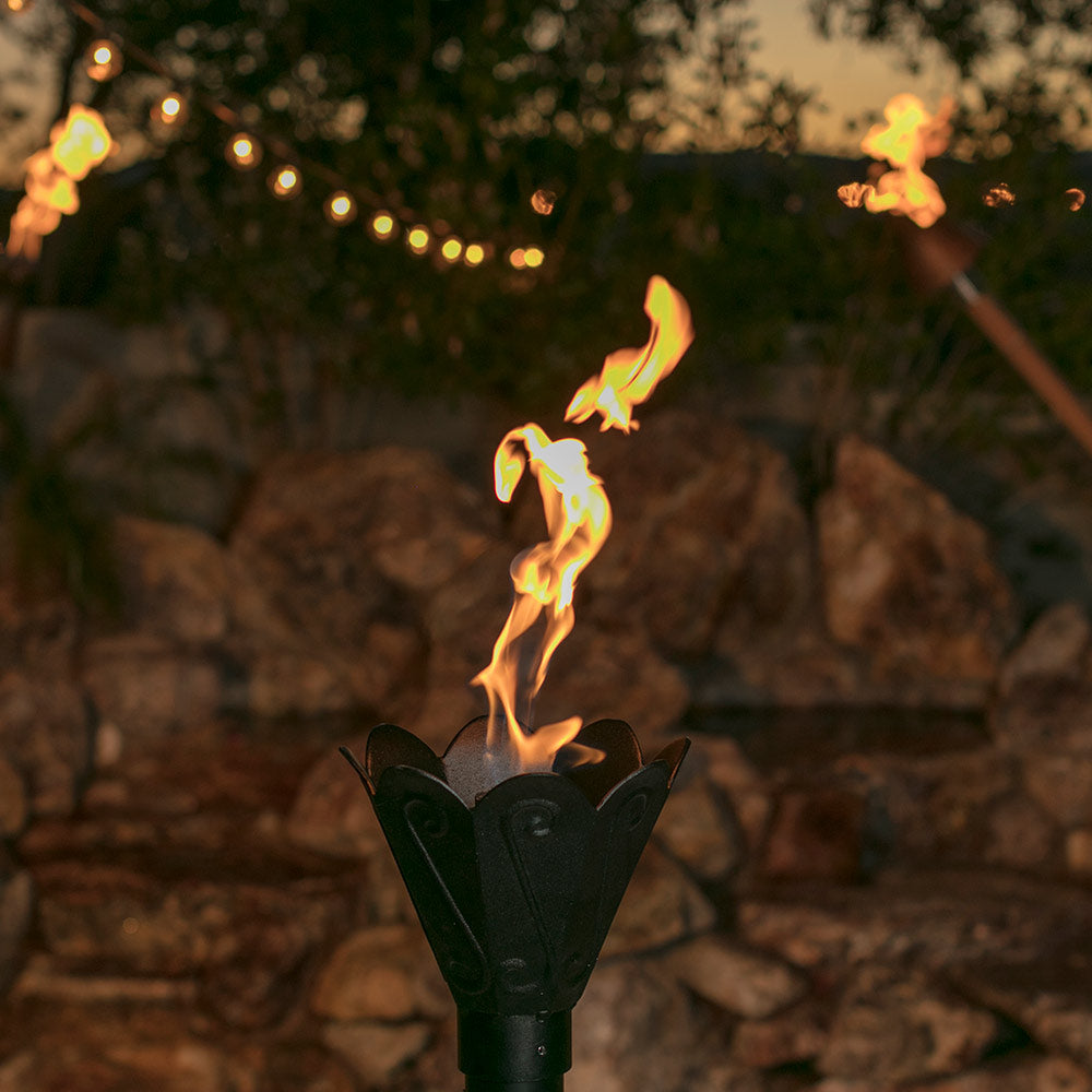 Outdoor gas torch with tulip head and visible flame